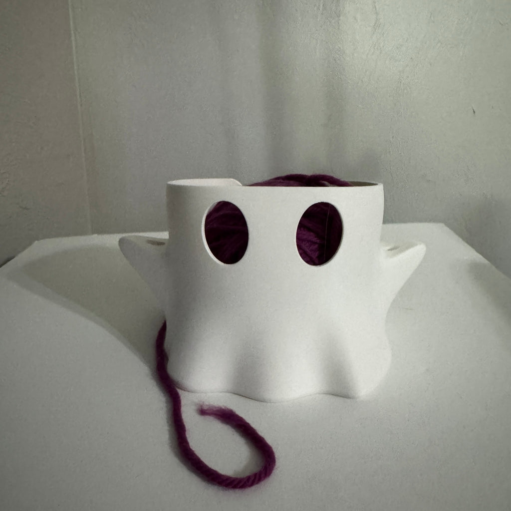 Boo Buddy matte white ghost yarn bowl holding a purple yarn ball
