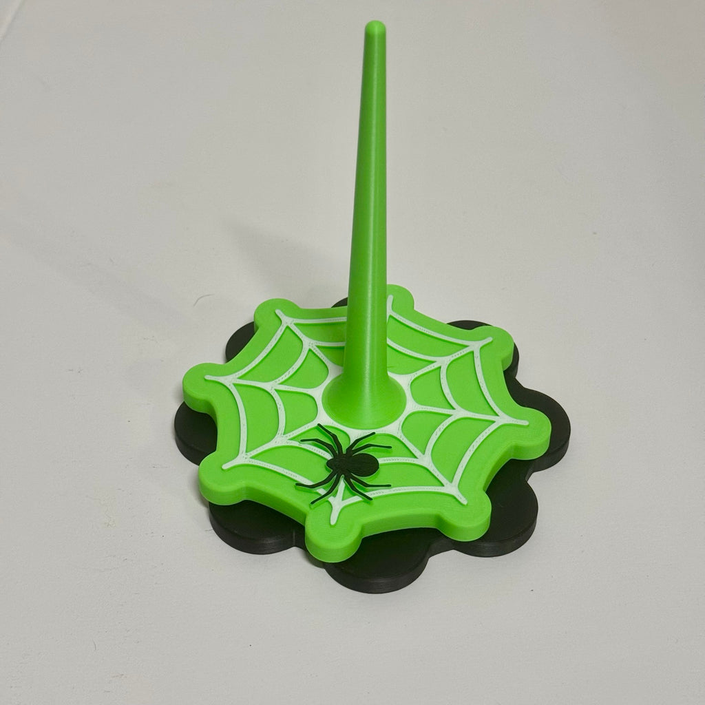 Spin a Little Spell Yarn Buddy in bright green with white spiderweb and black spider