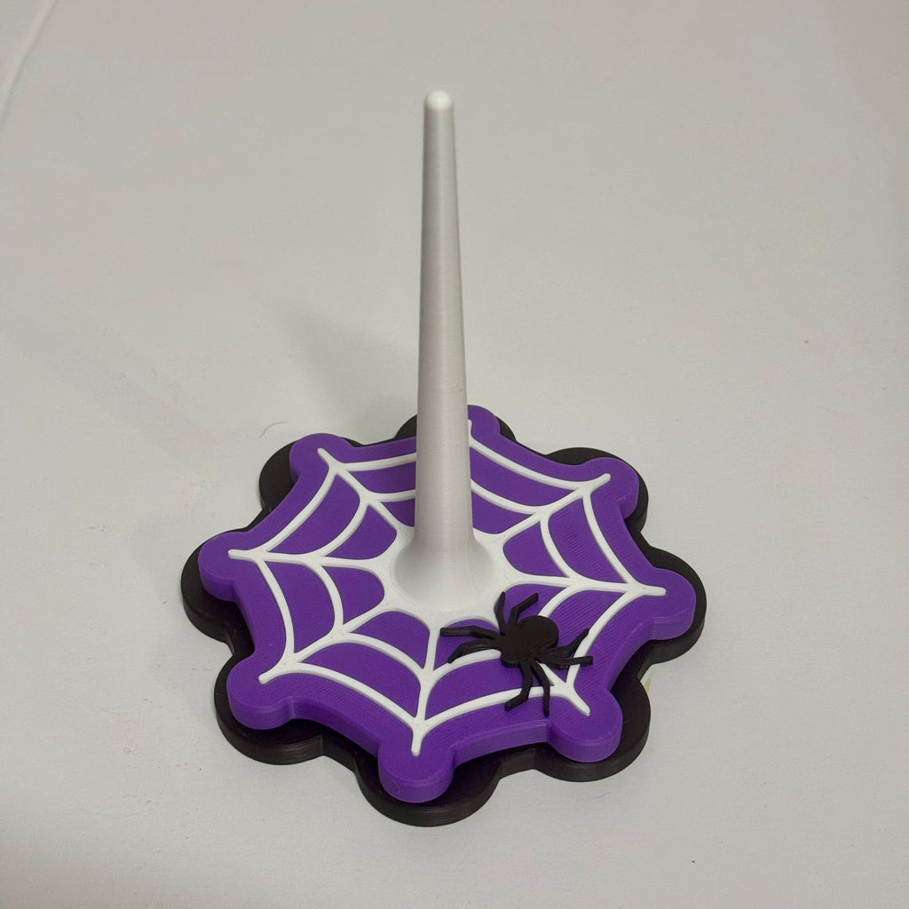 Spin a Little Spell Yarn Buddy in purple with white spiderweb and black spider